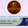 Uni-Scar Gel 20gm tube and box on white table with Adorabella logo and green natural background